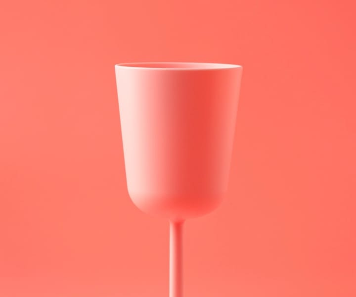 A pink cup with pink bacground